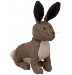 A cute fabric bunny doorstop made from a beige tweed fabric 