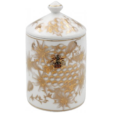 A golden trimmed candle pot decorated with a luxe Honeycomb design 