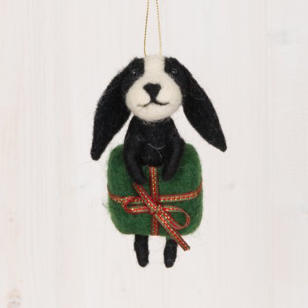 A sweet and small woollen hanging dog popping out of a present