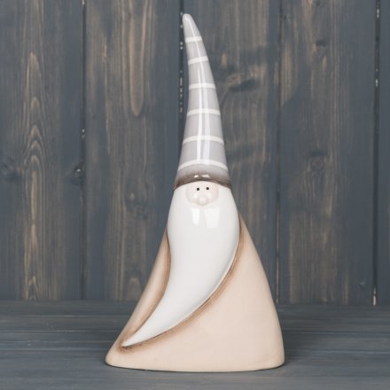  Perfect for placing in any home with a neutral setting, a small smooth ceramic Santa with a grey and beige tone 