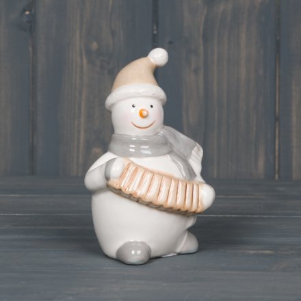 A sweet little smooth ceramic snowman playing an accordion  