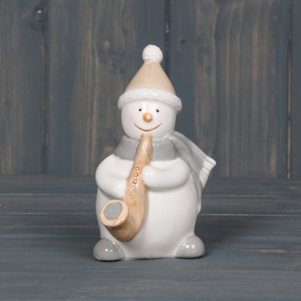  A sweet little smooth ceramic snowman playing an Saxophone  