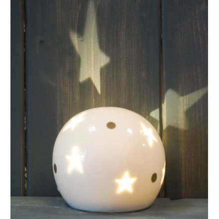 A small and simple rounded ceramic ball set with star cut details and added gold dots 