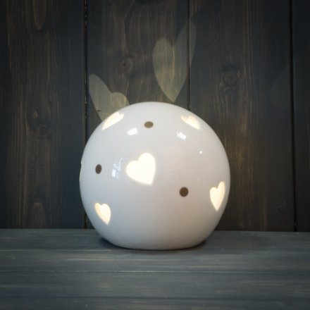  A stylishly simple round ceramic ball decoration set with gold dots and a warm glowing LED centre 