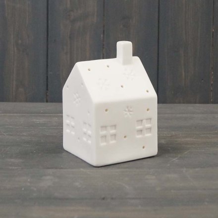A chic and simple little ceramic house decoration fitted with an illuminating led centre 