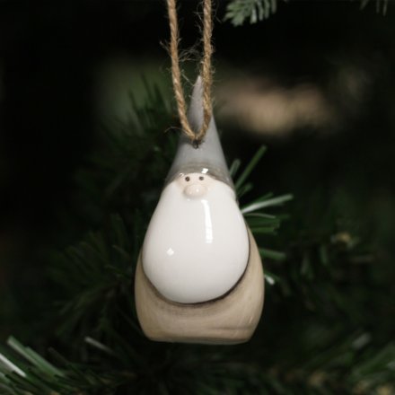  A smooth ceramic Santa decoration with added beige accents and a ribbon hanger 