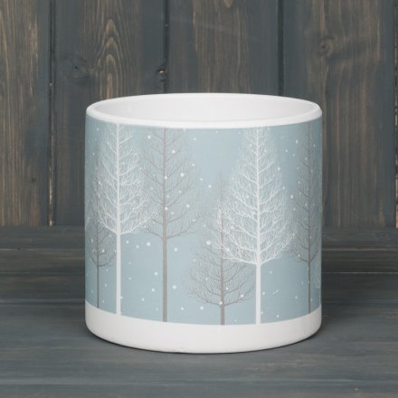   A large round planter pot beautifully decorated with a Winter Woodland scene 