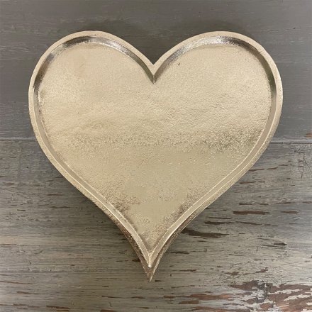 A simple heart shaped decorative plate with a distressed charm and silvered tone 
