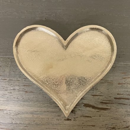 A simple heart shaped decorative plate with a distressed charm and silvered tone 