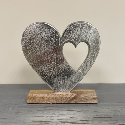  A simple and rustic inspired wooden decoration with an added aluminimum double heart display on it 