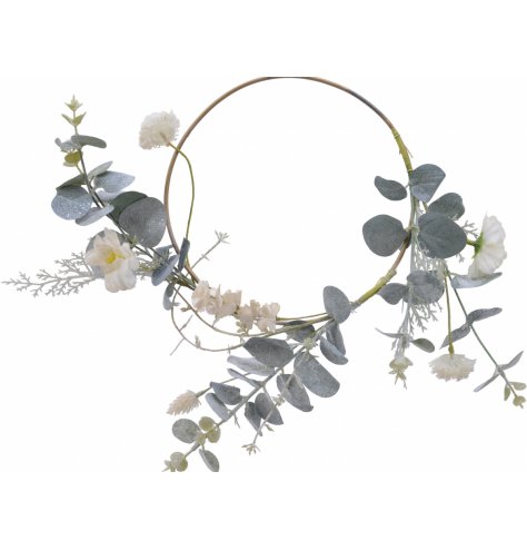 A beautiful, simple white and green wreath with eucalyptus and flowers. 