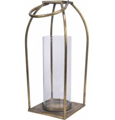 A simple metal lantern with a tarnished gold tone and rounded carry handle 