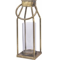 A simple iron lantern with a tarnished gold tone and rounded carry handle 