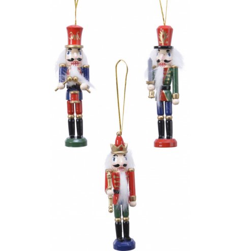 Traditional painted wooden nutcrackers with ribbon for hanging in three assorted designs. 