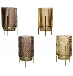 An assortment of ridge glass candle holders on golden metal stands 