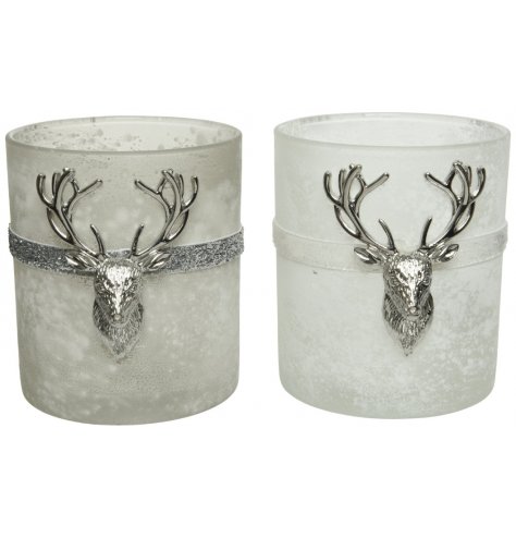 Two snow frosted glass t-light holders with metal bands and deer head detail.