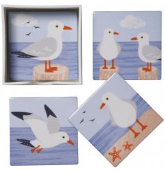 A set of 4 square ceramic coasters, each decorated with a coastal themed Seagull Print 