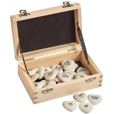 A box containing a variety of small marble heart tokens, each printed with its own text and illustration 
