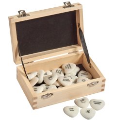 A small wooden box filled with marble heart tokens, 