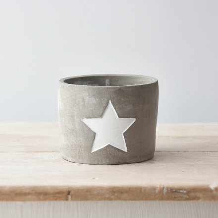 A rough luxe cement planter with a white painted star. A chic interior accessory for the home.