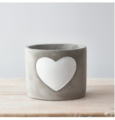 A chic cement planter with a white painted heart. A rough luxe, on trend interior accessory. 