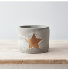 A rustic cement planter with a gold painted star. A rough luxe decorative accessory for the home.