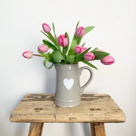 A beautiful grey ceramic jug with a pretty white heart design. 