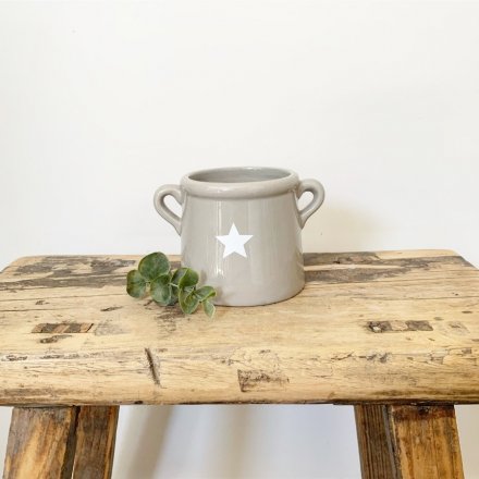 An effortlessly cool and stylish small ceramic pot with handles and a star design.