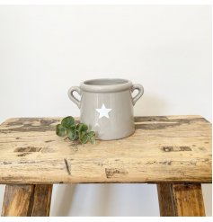 A small and chic ceramic pot with ears. Complete with a simple star decoration.