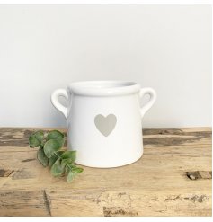 A stylish ceramic pot with twin ears and a pretty grey heart design.