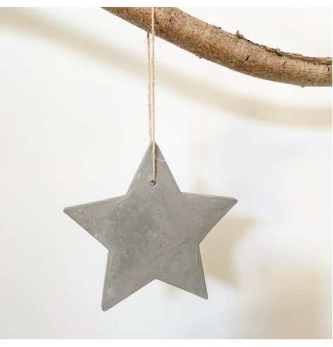 A hanging cement star decoration with jute string. A rustic item with a distressed finish.