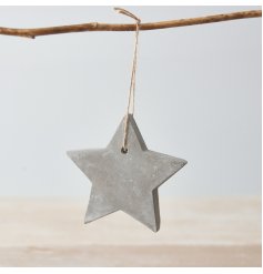 A rustic cement star decoration with a jute string hanger.