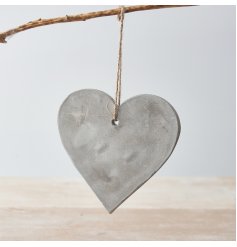 An effortlessly chic cement heart decoration with a jute string hanger.