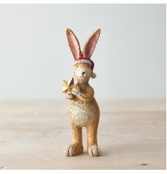 A cute and unique Christmas rabbit decoration with a gold star and Santa hat.