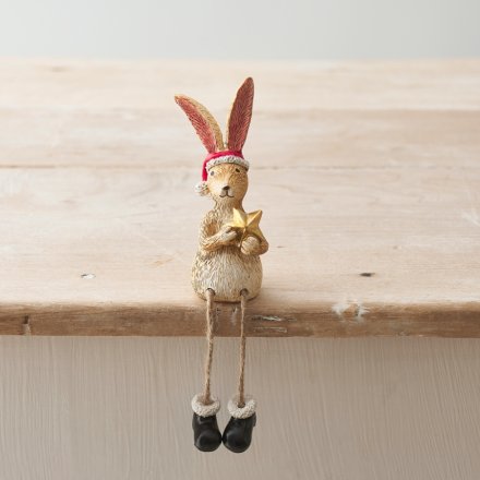 A wonderfully detailed sitting rabbit decoration, complete with a Santa hat, boots and gold star.