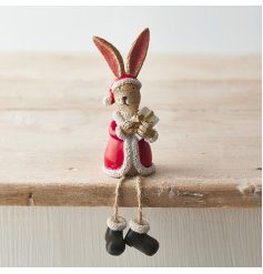 An adorable shelf sitting rabbit dressed as Santa. Complete with a wrapped present and boots.