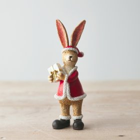 An adorable standing rabbit decoration complete with Santa hat and a wrapped present with gold ribbon.