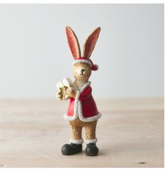 An adorable standing rabbit decoration complete with Santa hat and a wrapped present with gold ribbon.