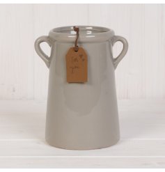  A tall ceramic vase with a grey tone and added faux leather tag 