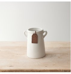 A timeless white ceramic vase with eared handles. Complete with a tan coloured PU Leather tag