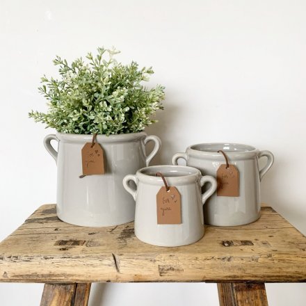 A chic ceramic pot planter with a grey washed finish. Complete with eared handles and a PU leather tag in tan.