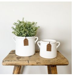 A beautiful and stylish ceramic pot in white. Complete with a PU leather tan coloured tag.