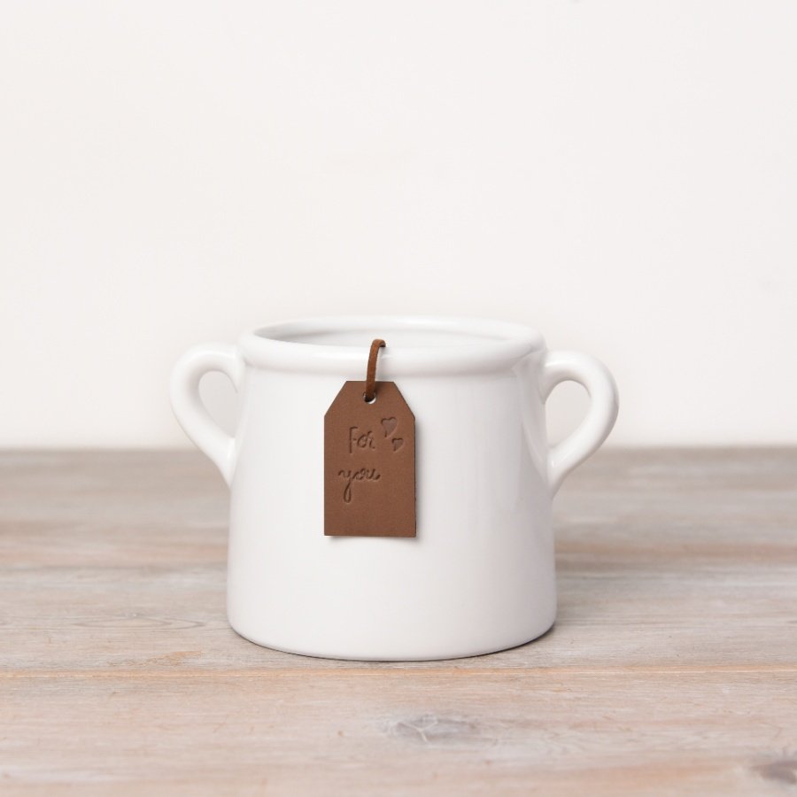 A beautiful and stylish ceramic pot in white. Complete with a PU leather tan coloured tag.