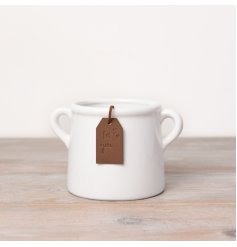 A beautiful and stylish ceramic pot in white. Complete with a PU leather tan coloured tag.