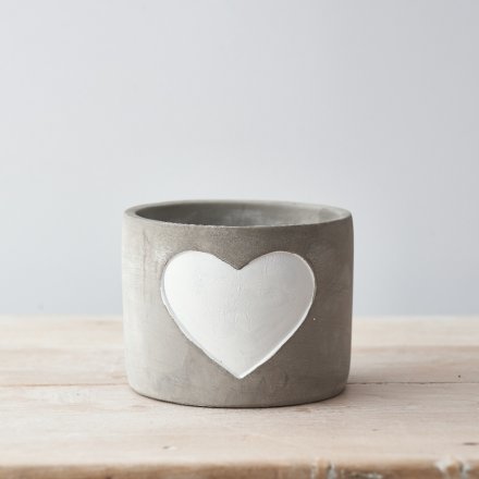 A chic and simple cement planter with a white painted heart.