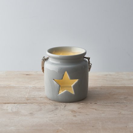 A rustic ceramic lantern with a star shaped cut out design. Complete with a chunky rope handle.