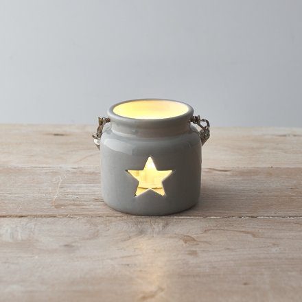 A rustic grey lantern with a star shaped cut out design. Complete with a chunky rope handle.