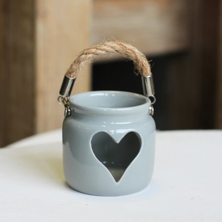 A rustic grey lantern with a heart shaped cut out feature. Complete with a chunky rope handle.