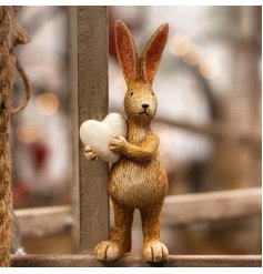 A charming standing rabbit ornament with tall pointed ears and a white heart.