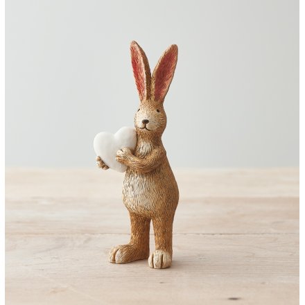 Fall in love with this simple and chic standing rabbit decoration with white heart decoration.